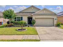 Charming single-story home with a well-manicured lawn, beautiful landscaping, and a two-car garage at 810 Jefferson Blvd, Haines City, FL 33844