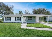 Inviting home with well-maintained lawn, fresh landscaping, and a neatly paved walkway at 818 Ballard St, Altamonte Springs, FL 32701