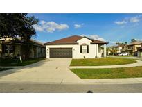 Charming single-story home with a well-maintained lawn and a two-car garage, perfect for suburban living at 1025 Belvoir Dr, Kissimmee, FL 34744