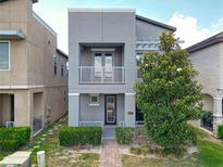 Modern two-story home with a small balcony and well-maintained landscaping at 11037 Bagley Aly, Windermere, FL 34786