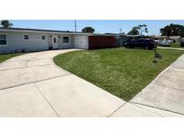 Well-maintained single-story home with a spacious front yard and long driveway at 1126 Orwell Ave, Orlando, FL 32809
