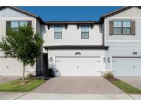 Charming townhome featuring a two-car garage and neat landscaping in a well-maintained community at 11378 Whistling Pine Way, Orlando, FL 32832