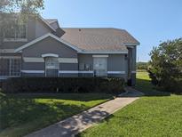 Charming single-Gathering home featuring a well-maintained lawn and lush landscaping at 13940 Corrine Key Pl, Orlando, FL 32824