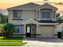 Charming two-story home with a well-manicured front yard and a paved driveway at 1425 Carey Glen Cir, Orlando, FL 32824