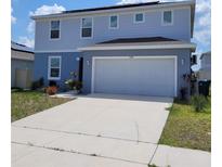 Charming two-story home with a spacious two car garage and a concrete driveway at 1556 Aspen Ave, Davenport, FL 33837
