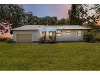 Charming single-story home with a metal roof and well-maintained lawn at 2740 Barker Rd, St Cloud, FL 34771