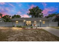 Charming single-story home featuring a well-manicured lawn, white fence, and inviting curb appeal at 416 E Seminole Ave, Lake Wales, FL 33853