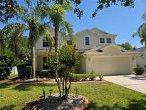 Charming two-story home with a well manicured lawn and beautiful landscaping at 5704 Ansley Way, Mount Dora, FL 32757