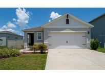 Charming single-story home with a two-car garage and well-maintained lawn at 1015 Andean Ln, Davenport, FL 33837