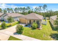 Charming single-story home with a well-manicured lawn, neutral paint, and an attached two-car garage at 1096 Roberta Rd, Lake Wales, FL 33853