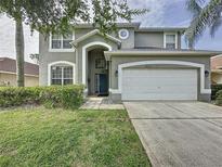 Charming two-story home with a well-maintained lawn and beautiful landscaping in a residential neighborhood at 1426 Park Park, Haines City, FL 33844