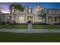 Charming two-story townhouse with landscaped front yard, inviting entrance and curb appeal at 2151 Valencia Blossom St, Clermont, FL 34711