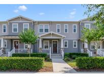 Charming two-story townhome with well-maintained landscaping and inviting front porch at 2224 Celebration Blvd, Celebration, FL 34747