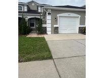 Charming single-Gathering home featuring a well-maintained lawn and attached two-car garage at 3244 River Branch Cir, Kissimmee, FL 34741