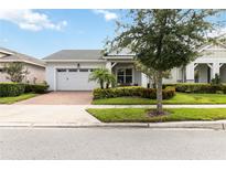 Charming single-story home with a two-car garage, landscaped front yard, and inviting front porch at 5025 Sunfalls Ave, St Cloud, FL 34772