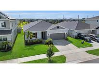 Charming single-Gathering home with manicured lawn, gray paint, and inviting curb appeal at 685 Overpool Ave, Davenport, FL 33896