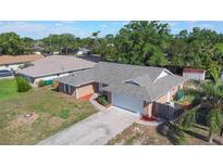 Well-maintained brick single-story home with a two-car garage, established landscaping, and concrete driveway at 1022 Blue Horizon Dr, Deltona, FL 32725