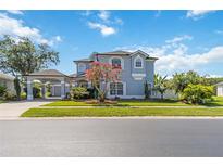 Charming two-story home with a well-manicured lawn, porte-cochere, and classic architectural details at 12134 Shadowbrook Ln, Orlando, FL 32828