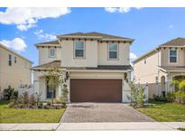 Charming two-story home with a brick driveway and a two-car garage at 1765 Petiole Pl, Kissimmee, FL 34744
