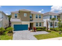 Charming two-story home featuring a blue garage door, neutral paint scheme, and well-manicured landscaping at 2408 Rama Dr, Kissimmee, FL 34746