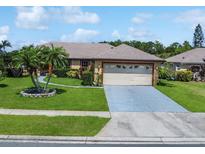 Charming single-story home with a well-manicured lawn and a two-car garage at 3811 Gator Bay Ln, St Cloud, FL 34772