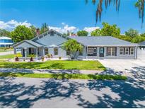 Charming home featuring a unique facade, complemented by a well-manicured lawn and an inviting driveway at 435 Pennsylvania Ave, St Cloud, FL 34769