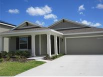 Charming single-story home featuring a two-car garage, manicured lawn, and covered front entry at 537 S Andrea Cir, Haines City, FL 33844