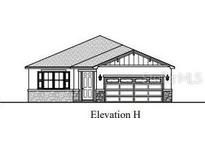Charming single-story home with a stone-accented facade and an attached two-car garage at 163 Waterstone Loop, Tavares, FL 32778