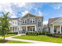 Charming two-story home with a cozy front porch and well-maintained landscaping at 2057 Celebration Blvd, Kissimmee, FL 34747
