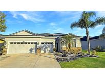 Stunning two-car garage home with a well-manicured lawn and tropical landscaping at 2164 Crosston Cir, Orlando, FL 32824