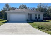 Charming single-story home featuring a well-manicured lawn and a spacious two-car garage at 246 Cheshire Ct, Kissimmee, FL 34758