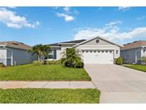 Charming single-story home with well-manicured lawn and two-car garage at 3211 Sweet Acres Pl, St Cloud, FL 34772