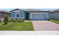 Charming single-story home featuring a well-maintained lawn and a brick-paved driveway at 3214 Viceroy Ct, Kissimmee, FL 34759