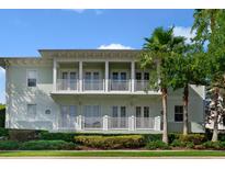 Inviting two-story condo with dual balconies and lush tropical landscaping at 7468 Excitement Dr # 101, Reunion, FL 34747