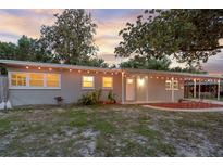 Charming single story home with welcoming front porch and a well-maintained yard under a beautiful sunset at 807 E Airport Blvd, Sanford, FL 32773