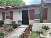Charming home exterior with sidewalk, mulch landscaping, and neutral colored stucco at 13 W Marbrisa Way, Kissimmee, FL 34743