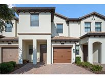 Beautiful two-story townhome featuring a private garage and covered entryway at 1312 Royal St George Blvd, Davenport, FL 33896