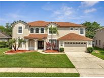 Spacious two-story home with a well-manicured lawn and a two-car garage and beautiful landscaping at 13130 Meergate Cir, Orlando, FL 32837