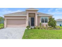 Inviting single-story home featuring a brick driveway and a welcoming covered entrance at 172 Roseville Dr, Haines City, FL 33844