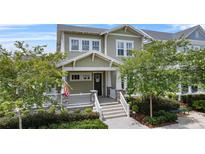 Charming two-story home with a welcoming front porch and lush landscaping at 1801 Coastal Ct, Celebration, FL 34747