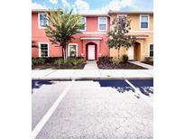 Charming townhome with colorful exterior, well-maintained landscaping, and a welcoming front entrance at 3014 Red Ginger Rd, Kissimmee, FL 34747