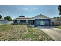Charming single story home with brick facade, solar panels, and landscaped front yard at 31 Lake Link Se Cir, Winter Haven, FL 33884