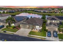 Beautiful home with a water view, solar panels, landscaped yard, and large driveway in a well-maintained community at 3698 Cortland Dr, Davenport, FL 33837