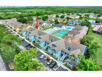 Bright and airy condo community featuring a pool, tennis courts, parking, and mature trees at 8716 Rain Forest Pl # D, Kissimmee, FL 34747