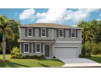 Charming two-story home boasts a manicured lawn, gray siding, and a convenient two-car garage at 1022 Wisteria Way, Dundee, FL 33838