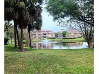 Scenic view of a pond with a fountain in a well-maintained community at 13838 Fairway Island Dr # 1418, Orlando, FL 32837