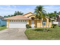 Charming single-story home featuring a two-car garage and well-maintained landscaping at 1914 Ellery Ln, Kissimmee, FL 34746