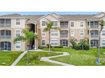 Beautiful condominium building featuring lush landscaping and outdoor living spaces at 2307 Silver Palm Dr # 304, Kissimmee, FL 34747