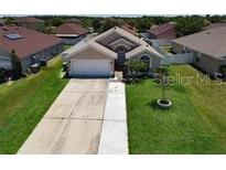 Charming single-story home with well-manicured lawn and a two-car garage at 3030 Eagle Crossing Dr, Kissimmee, FL 34746