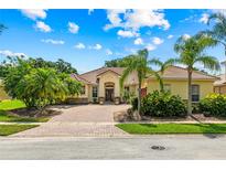Charming single-story home with beautiful landscaping, brick driveway, and a tile roof in a sunny setting at 3427 Harborside Ct, Kissimmee, FL 34746